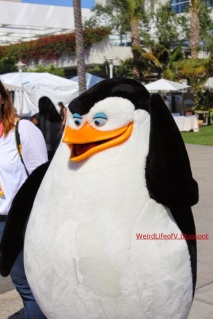People dressed as the Penguins of Madagascar walking around outside San Diego Comic Con 2014