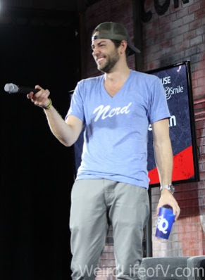 Zachary Levi laughing at something an audience member said or did